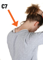 women lifting her hair to reveal her c7 vertebrae
